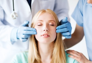 a woman during a consultation at a plastic surgeon before facial cosmetic procedure 