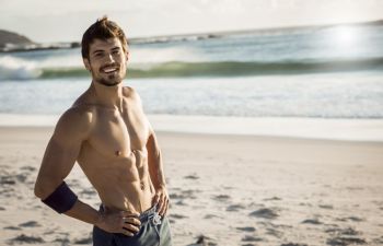 Athletic lean man on the beach